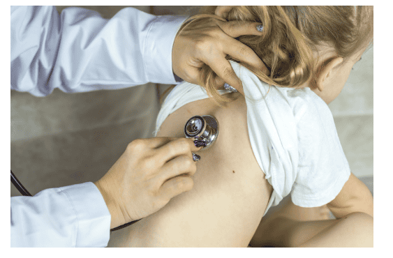 Child being examined by doctor with stethoscope.